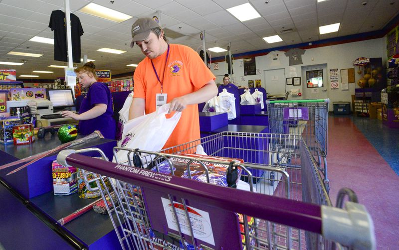 FILE - James Pratt, head cashier at Phantom Fireworks in Hinsdale, N.H., helps bag a customer's order on June 28, 2024. (Kristopher Radder /The Brattleboro Reformer via AP, File)