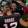 Atlanta Falcons head coach Raheem Morris hugs wide receiver KhaDarel Hodge (12) after Hodge scored the game-winning touchdown against the Tampa Bay Buccaneers during overtime in an NFL football game Friday, Oct. 4, 2024, in Atlanta. (AP Photo/John Bazemore)