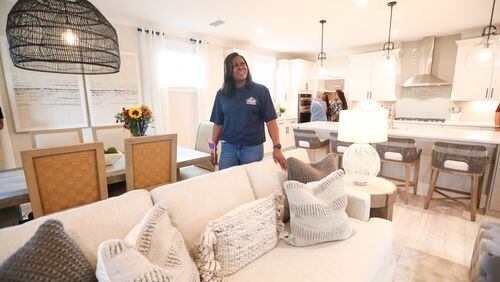 U.S. Army Sgt. (Ret) Keysia Calmese looks around in disbelief as she walks through her new mortgage free home on Friday, November 10, 2023 at Heartwood in Richmond Hill.