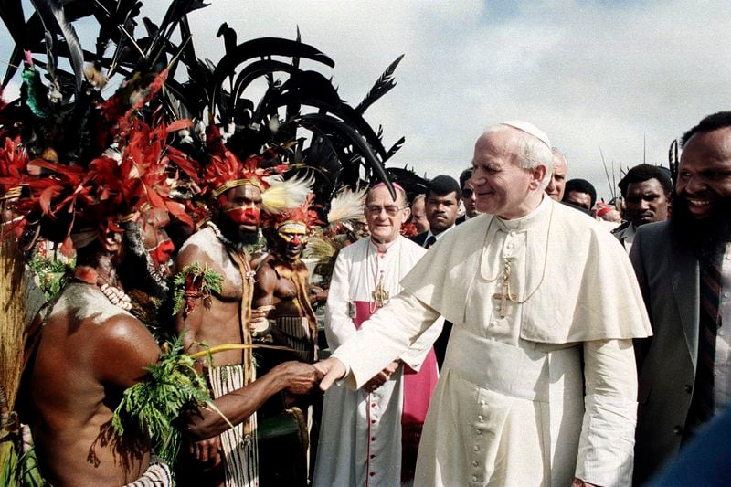 FILE - Pope John Paul II is greeted by Papua New Guinea Highland natives on his visit to Mt. Hagen, Papua New Guinea, on May 8, 1984. (AP Photo, File)