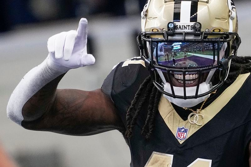 New Orleans Saints running back Alvin Kamara reacts after scoring a long touchdown run against the Dallas Cowboys during the first half of an NFL football game, Sunday, Sept. 15, 2024, in Arlington, Texas. (AP Photo/Tony Gutierrez)