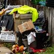 Waste and other materials are often stacked in side yards and near the street at homes with no trash can in Chickasaw, Alabama. (Photo Courtesy of Lee Hedgepeth/Inside Climate News)