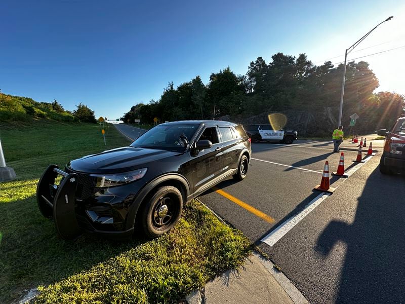 Police block a ramp to Interstate 95 and the Piscataqua River Bridge in Portsmouth, N.H. after a man connected to a homicide was fatally shot by police and an 8-year-old child was found shot to death in the man’s car on the bridge that connects New Hampshire to Maine, Thursday, Aug. 29, 2024. (AP Photo/Caleb Jones)