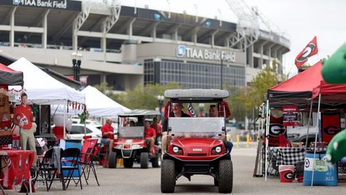 Georgia fans drive utility vehicles through RV City outside of TIAA Bank Field, Friday, October 28, 2022, in Jacksonville, Florida, ahead of Saturday's annual Georgia-Florida game. (Jason Getz / Jason.Getz@ajc.com)