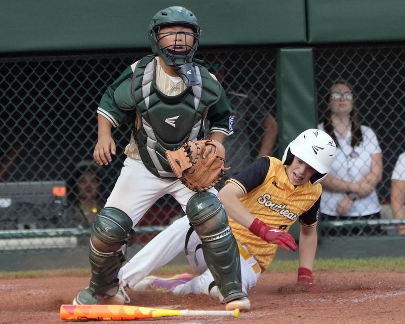 Lake Mary, Fla.'s Lathan Norton slides past catcher Taiwan's Yu Chia-Jui scoring the winning run on Hunter Alexander's bunt during the eighth inning of the Little League World Series Championship game in South Williamsport, Pa., Sunday, Aug. 25, 2024. (AP Photo/Tom E. Puskar)