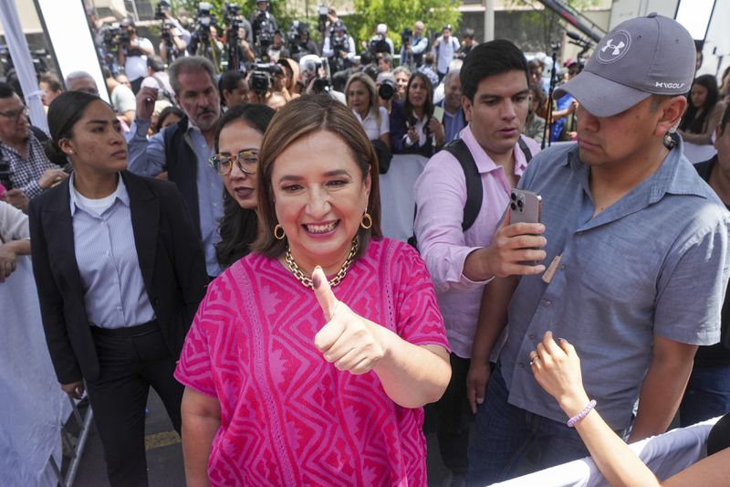 FILE - Opposition presidential candidate Xóchitl Gálvez shows her inked-stained thumb as she leaves a polling station after voting in the general election, in Mexico City, Sunday, June 2, 2024. (AP Photo/Fernando Llano, File)