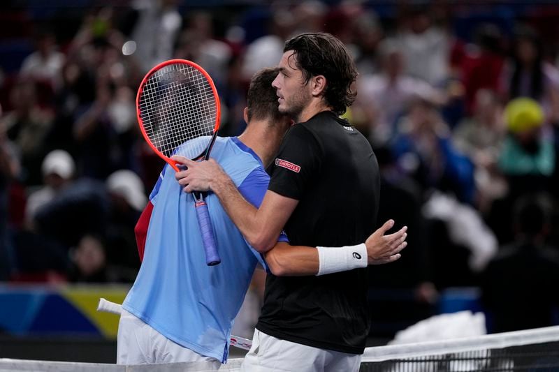 Taylor Fritz of the United States, right, is congratulated by Terence Atmane of France after winning in the men's singles second round match in the Shanghai Masters tennis tournament at Qizhong Forest Sports City Tennis Center in Shanghai, China, Monday, Oct. 7, 2024. (AP Photo/Andy Wong)