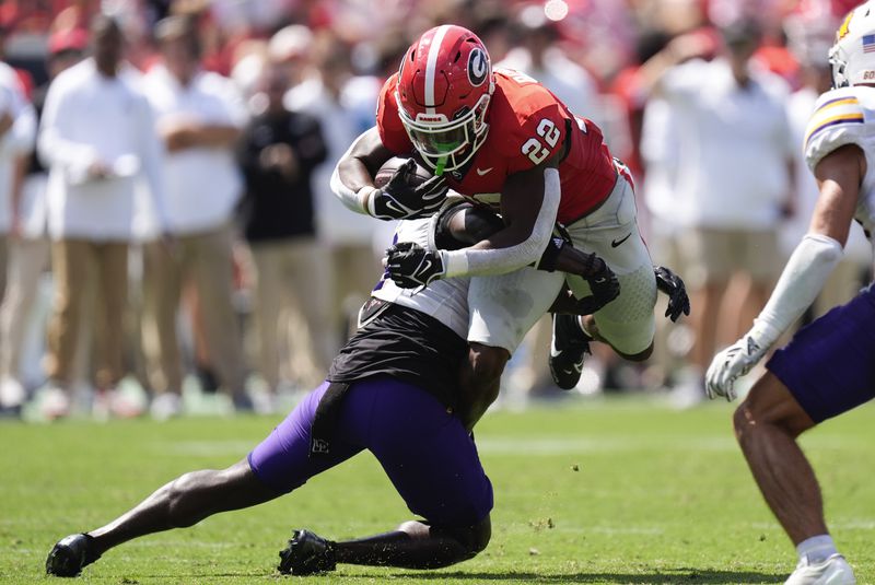 Georgia running back Branson Robinson (22) is stopped by Tennessee Tech defensive back Jalin Shephard (6) after a catch during the first half of an NCAA college football game Saturday, Sept. 7, 2024, in Athens, ga. (AP Photo/John Bazemore)