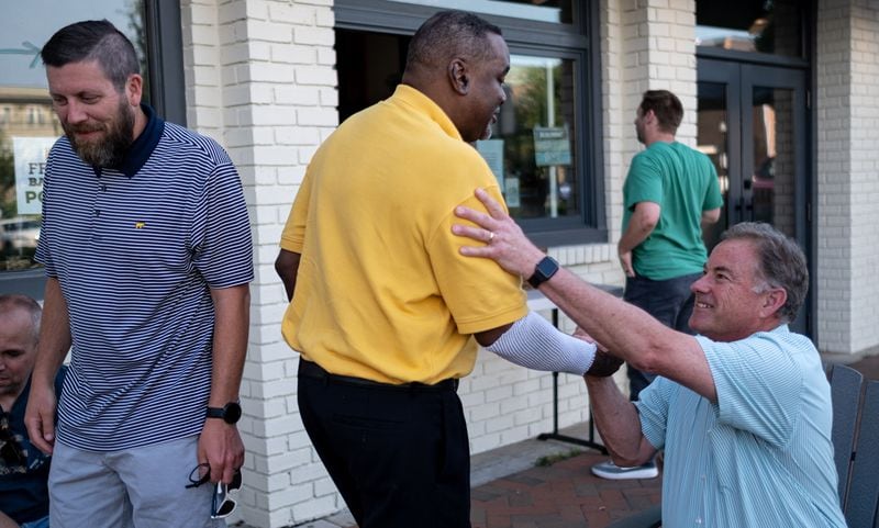 John Hodges, center, says goodbye to George Scarborough before leaving a meeting of the Bridge the Gap Christian Men’s Fellowship Group on Monday evening June 14, 2021 in Alpharetta. (Ben Gray for the Atlanta Journal-Constitution)