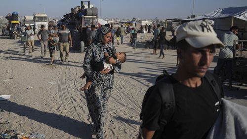 Palestinians flee the Khan Younis area of the Gaza Strip, following Israeli military evacuation orders, saying its forces will soon operate there, Thursday, Aug. 8, 2024. (AP Photo/Abdel Kareem Hana)