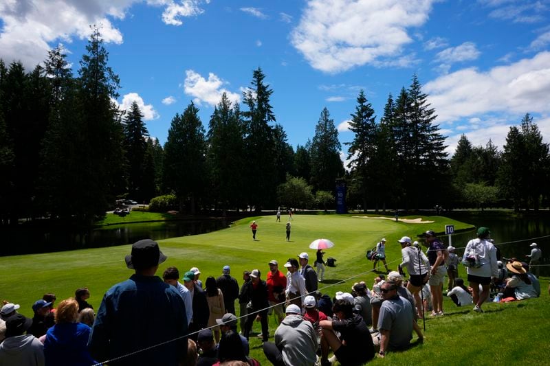 Amy Yang, of South Korea, Lauren Hartlage and Miyu Yamashita, of Japan, stand on the tenth hole during the final round of the Women’s PGA Championship golf tournament at Sahalee Country Club, Sunday, June 23, 2024, in Sammamish, Wash. (AP Photo/Lindsey Wasson)