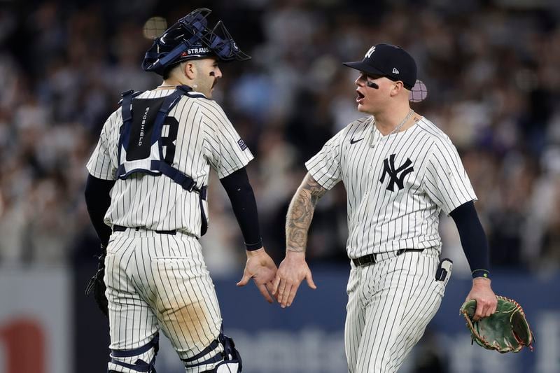 New York Yankees catcher Austin Wells (28) and outfielder Alex Verdugo celebrate after defeating the Kansas City Royals in Game 1 of the American League baseball division series, Saturday, Oct. 5, 2024, in New York. (AP Photo/Adam Hunger)