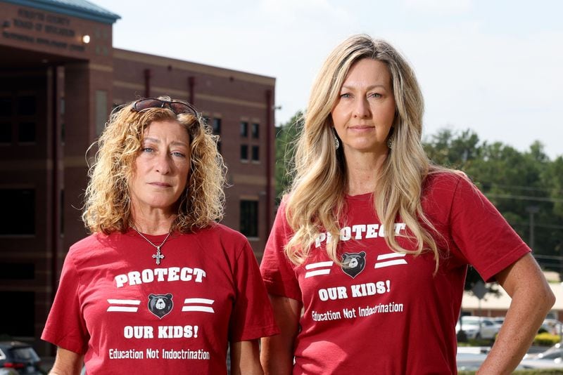 Alison Hair (left) and Cindy Martin stand in front of the Forsyth County Schools building on Aug. 15, 2022, in Cumming, Georgia. Hair and Martin, who dubbed themselves as the "Mama Bears," have been vocal in their opposition of materials they believe are sexually offensive and inappropriate for students. (Jason Getz/Atlanta Journal-Constitution/TNS)