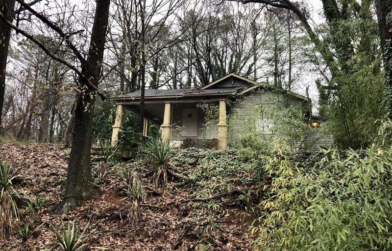 A boarded up home in the Carey Park neighborhood west of Midtown Atlanta sits in an area where two well-known players in Atlanta real estate planned a sweeping redevelopment. Those two speculators, Brock Built Homes President Steve Brock, and broker Gregory Todey, are now gripped in a legal battle with Brock claiming Todey defrauded him of his interests in distressed land near the future Westside Park at Bellwood Quarry. J. SCOTT TRUBEY/SCOTT.TRUBEY@AJC.COM