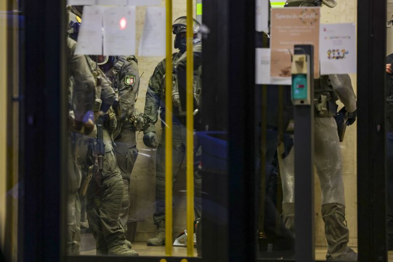 Special police forces carry out an operation at a refugee shelter in Solingen, Germany, on Saturday, Aug. 24, 2024, during an investigation into a fatal knife attack at the city's 650th anniversary celebrations. (Christoph Reichwein/dpa via AP)