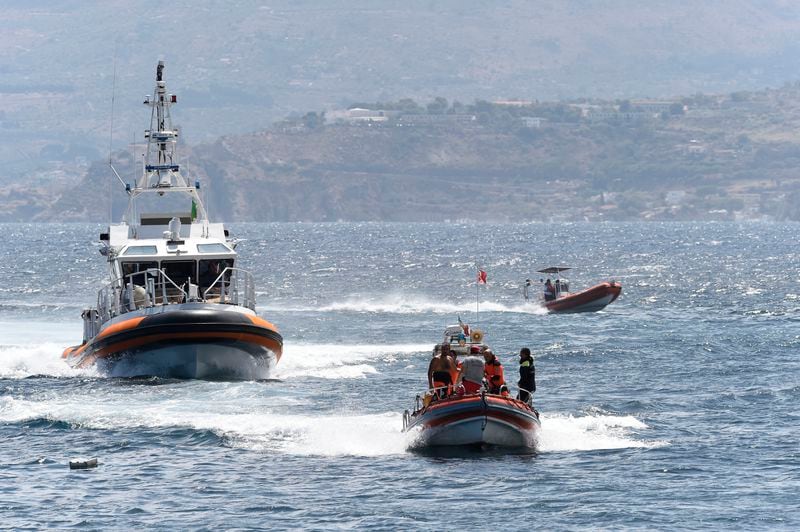 Emergency services at the scene of the search for a missing boat, in Porticello, southern Italy, Tuesday, Aug. 20, 2024. Rescue teams and divers returned to the site of a storm-sunken superyacht Tuesday to search for six people, including British tech magnate Mike Lynch, who are believed to be still trapped in the hull 50 meters (164-feet) underwater. (AP Photo/Salvatore Cavalli)