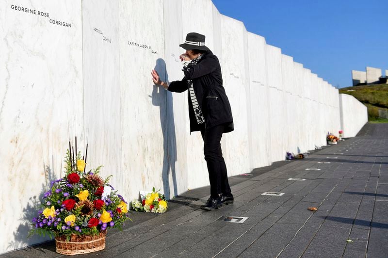 Sheryl Stoll, of Columbus, Ohio and cousin of Flight 93 pilot Capt. Jason M. Dahl, pays her respects at the Wall of Names prior to the start of the 23rd Anniversary of September 11th Memorial Service at the Flight 93 National Memorial near Shanksville, Pa., on Wednesday, Sept. 11, 2024. (Thomas Slusser/The Tribune-Democrat via AP)