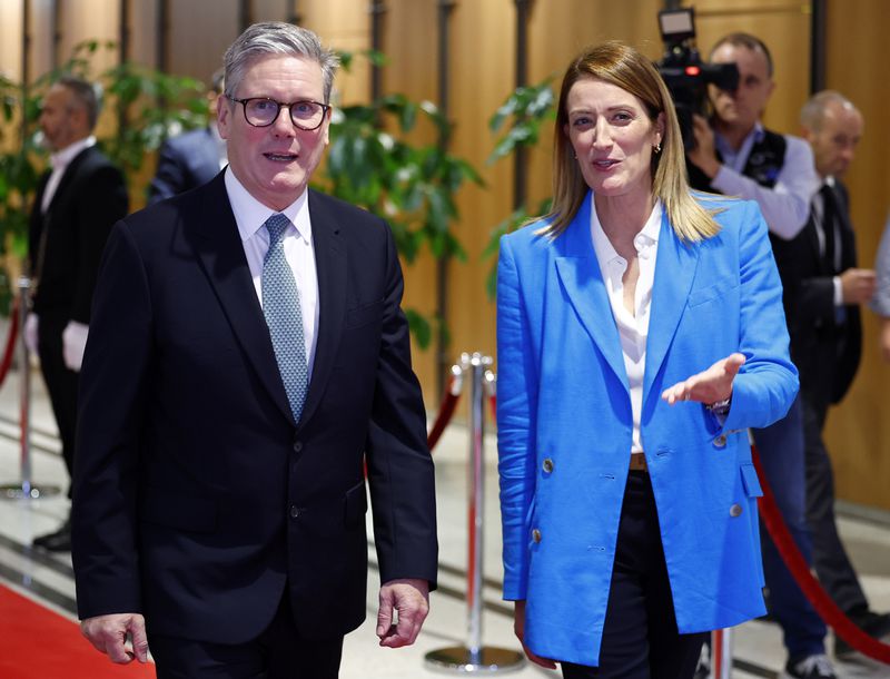 Britain's Prime Minister Keir Starmer, left, with European Parliament President Roberta Metsola at the European Commission headquarters in Brussels, Wednesday, Oct. 2, 2024. (Benjamin Cremel/Pool Photo via AP)