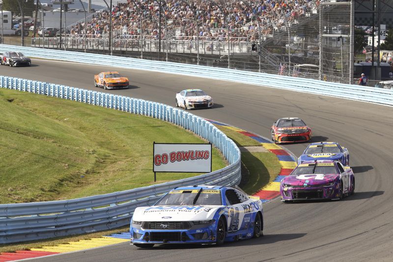 Chase Briscoe (14) drives through the during a NASCAR Cup Series auto race, Sunday, Sept. 15, 2024, in Watkins Glen, N.Y. (AP Photo/Lauren Petracca)