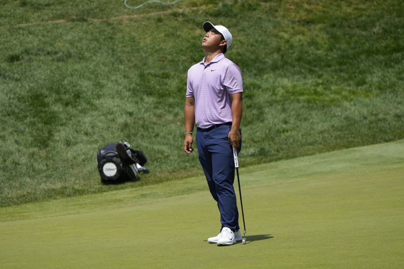 Tom Kim, of South Korea, reacts to a missed putt on the 18th green during the second round of the Travelers Championship golf tournament at TPC River Highlands, Friday, June 21, 2024, in Cromwell, Conn. (AP Photo/Seth Wenig)