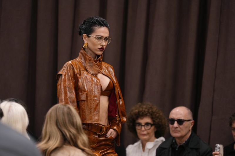 A model wears a creation as part of the Ferrari Spring Summer 2025 collection, that was presented in Milan, Italy, Saturday, Sept. 21, 2024. (AP Photo/Luca Bruno).