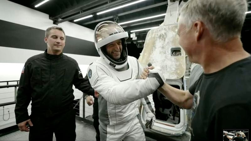 In this image made from SpaceX video, tech entrepreneur Jared Isaacman, center, greets as he gets out of its capsule upon his return with his crew after the capsule landed in the Gulf of Mexico near Florida's Dry Tortugas early Sunday, Sept. 15, 2024. (SpaceX via AP)