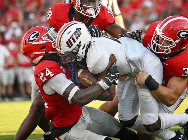 UT Martin's running back Sam Franklin (2) is stopped by Georgia's defensive back Malaki Starks (24) and Georgia's linebacker Chaz Chambliss (32) during the first half in an NCAA football game at Sanford Stadium, Saturday, September 2, 2023, in Athens. (Hyosub Shin / Hyosub.Shin@ajc.com)