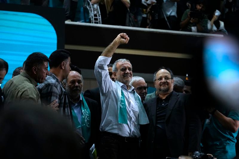Reformist candidate for Iran's June 28, presidential election Masoud Pezeshkian clenches his fist in a campaign meeting in Tehran, Iran, Sunday, June 23, 2024. (AP Photo/Vahid Salemi)