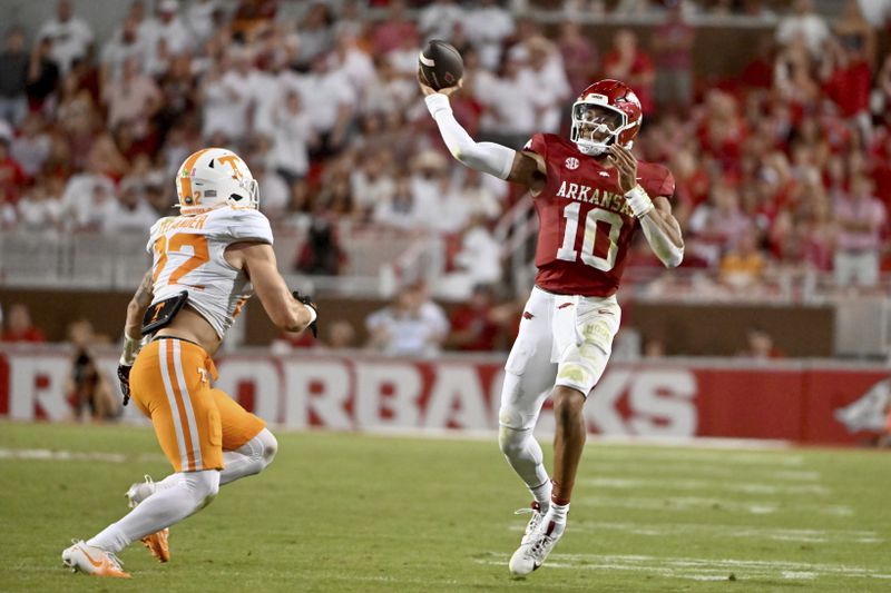 Arkansas quarterback Taylen Green (10) throws a pass over Tennessee linebacker Jeremiah Telander (22) during the first half of an NCAA college football game, Saturday, Oct. 5, 2024, in Fayetteville, Ark. (AP Photo/Michael Woods)