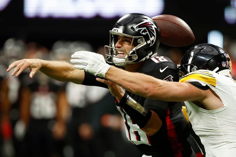 Atlanta Falcons quarterback Kirk Cousins (18) loses the ball as he is hit by Pittsburgh Steelers linebacker T.J. Watt during the second half of an NFL football game Sunday, Sept. 8, 2024, in Atlanta. (AP Photo/Butch Dill)