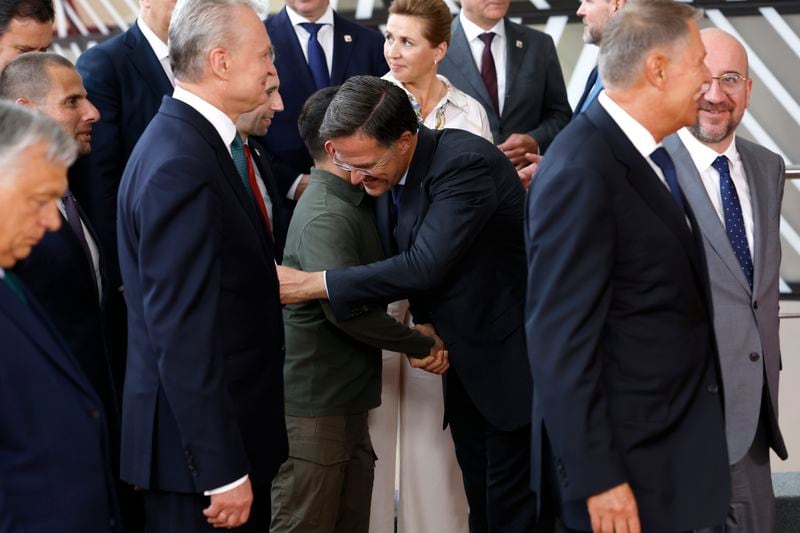 Netherland's Prime Minister Mark Rutte, center right, greets Ukraine's President Volodymyr Zelenskyy, center left, during a group photo at an EU summit in Brussels, Thursday, June 27, 2024. European Union leaders are expected on Thursday to discuss the next EU top jobs, as well as the situation in the Middle East and Ukraine, security and defence and EU competitiveness. (AP Photo/Geert Vanden Wijngaert)