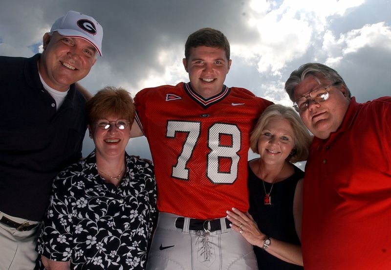 UGA lineman Jon Stinchcomb with his parents from left, Gary and Estelle Stinchcomb and Karen and J.R. Johnson on Aug. 17, 2002 in Athens. Though his birth parents Gary and Karen are divorced, they are still friends and are very supportive of Jon. Both sets of his parents often tailgate together before games. (Brant Sanderlin/AJC file photo)