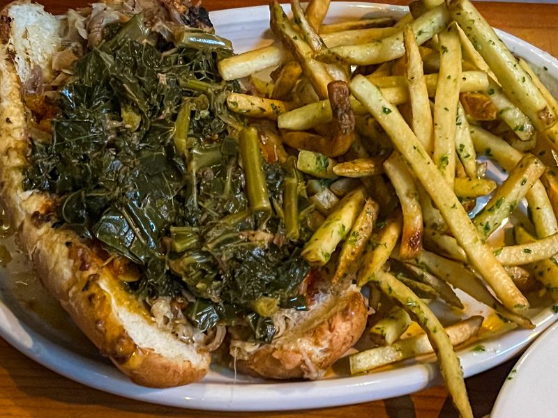 The roast pork sandwich by way of Philadelphia is the menu’s crowning achievement at the Porter. (Henri Hollis/henri.hollis@ajc.com)