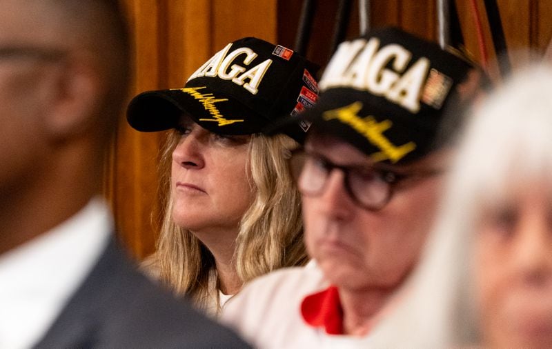 Members of the public wearing MAGA hats watch a State Election Board meeting Tuesday at the Georgia Capitol in Atlanta.