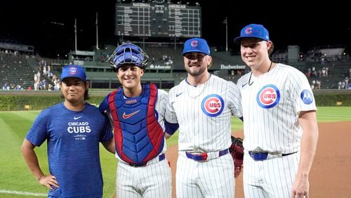 Chicago Cubs, from left, starting pitcher Shota Imanaga, catcher Miguel Amaya, and relief pitchers Porter Hodge and Nate Pearson, pose for a photo after they had a combined no-hitter against the Pittsburgh Pirates in the team's 12-0 win in a baseball game Wednesday, Sept. 4, 2024, in Chicago. (AP Photo/Charles Rex Arbogast)