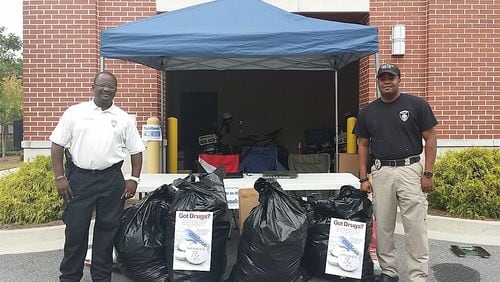 Snellville police officers ready to dispose of unused prescription drugs.