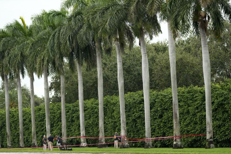 Law enforcement officials work at the scene of the Trump International Golf Club in the aftermath of the apparent assassination attempt of Republican presidential nominee and former President Donald Trump Tuesday, Sept. 17, 2024, in West Palm Beach, Fla. (AP Photo/Lynne Sladky)