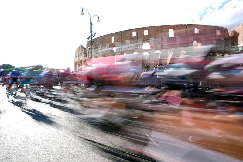 Cyclists ride past the ancient Colosseum during the final stage of the Giro d'Italia cycling race in Rome, Sunday, May 26, 2024. (AP Photo/Andrew Medichini)