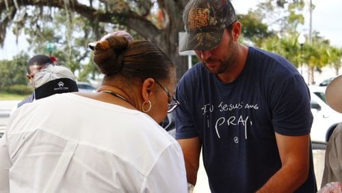 MLB pitcher Adam Wainwright serves shrimp during the lunch break outside the Ahmaud Arbery murder trial on Thursday.