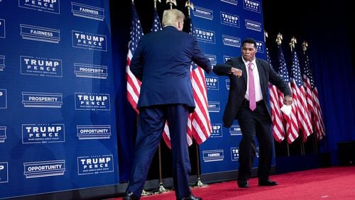 President Donald Trump is greeted by NFL Hall of Famer Herschel Walker during an event for black supporters at the Cobb Galleria Centre in Atlanta on September 25, 2020. (Brendan Smialowski/AFP via Getty Images/TNS)