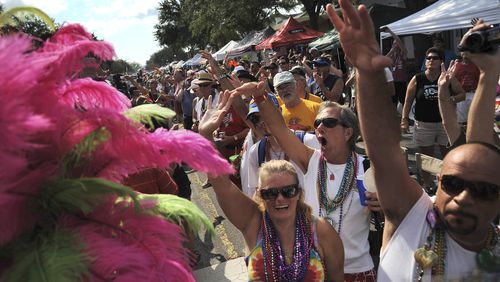 FILE - Hundreds of people line Central Avenue and cheer as the Flamingo Resort entry passes by during the 10th Annual St. Pete Pride Street Festival & Promenade in St. Petersburg, Fla. on June 30, 2012. (Leah Millis/Tampa Bay Times via AP, file)