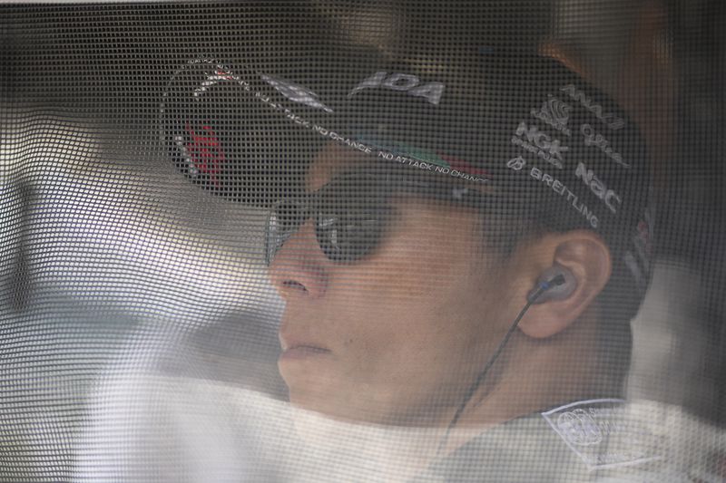 Takuma Sato, of Japan, stands behind a screen in his pit box during a practice session for the Indianapolis 500 auto race at Indianapolis Motor Speedway, Monday, May 20, 2024, in Indianapolis. (AP Photo/Darron Cummings)
