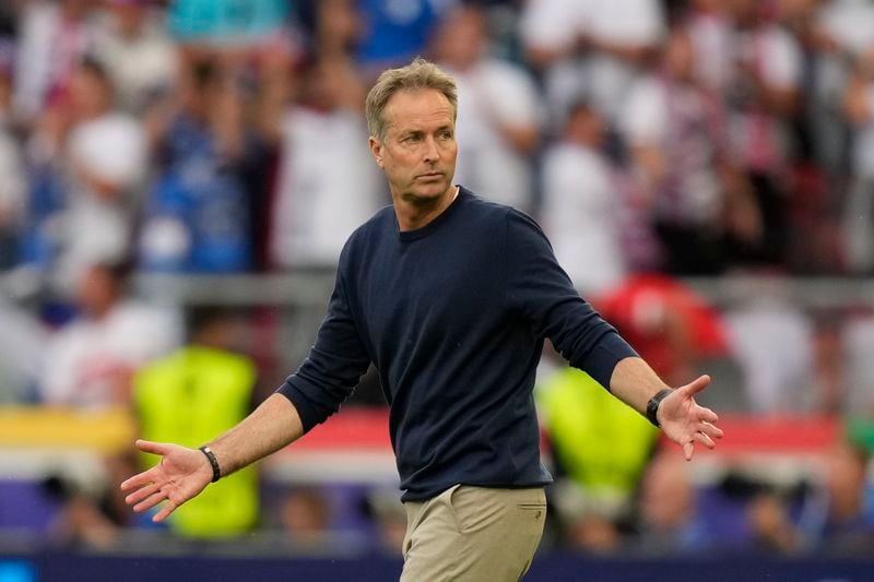 Denmark's head coach Kasper Hjulmand reacts as he walks onto the pitch after the of the Group C match between Slovenia and Denmark at the Euro 2024 soccer tournament in Stuttgart, Germany, Sunday, June 16, 2024. The game ended 1-1. (AP Photo/Matthias Schrader)