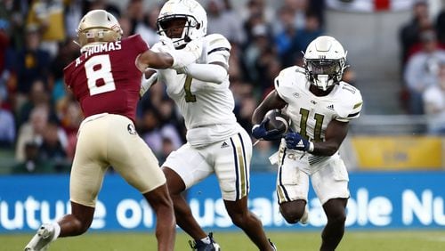 Jamal Haynes (11) scored two touchdowns as Georgia Tech rushed for 190 yards in its 24-21 victory over Florida State.