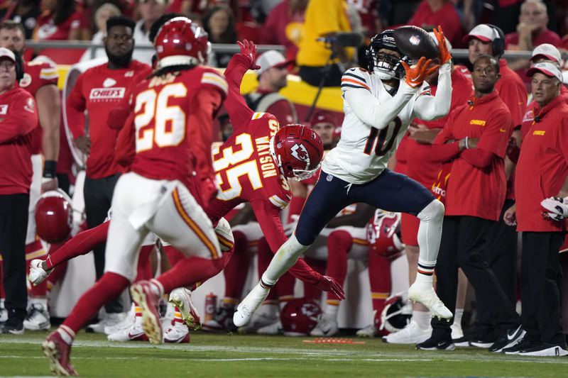 Chicago Bears wide receiver Tyler Scott (10) catches a 37-yard pass as Kansas City Chiefs cornerback Jaylen Watson (35) and safety Deon Bush (26) defend during the first half of an NFL preseason football game Thursday, Aug. 22, 2024, in Kansas City, Mo. (AP Photo/Charlie Riedel)