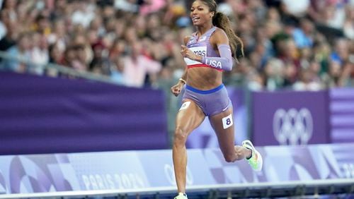 Gabrielle Thomas, of the United States, wins a women's 200 meters semifinal at the 2024 Summer Olympics, Monday, Aug. 5, 2024, in Saint-Denis, France. (AP Photo/Ashley Landis)