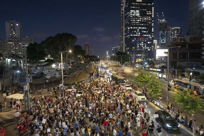 Relatives of hostages held by Hamas in the Gaza Strip and their supporters protest in Tel Aviv, Israel, Thursday, Aug. 15, 2024. (AP Photo/Ohad Zwigenberg)