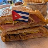 The pressed Cuban sandwich from Azucar Cuban Cuisine is a classic combination of slow-roasted pork, ham, Swiss cheese, dill pickles, mayonnaise and mustard. (Paula Pontes for The Atlanta Journal-Constitution)