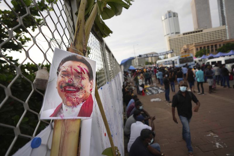 FILE- A vandalized portrait of Prime Minister Mahinda Rajapaksa is seen at a protest site outside President Gotabaya Rajapaksa's office in Colombo, Sri Lanka, Saturday, April 23, 2022. (AP Photo/Eranga Jayawardena, File)