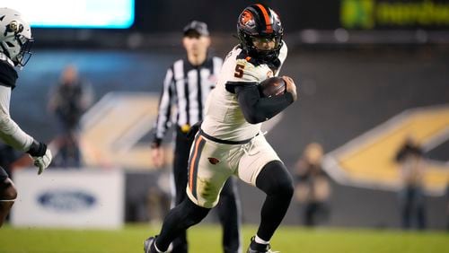 FILE - Then-Oregon State quarterback DJ Uiagalelei (5) plays in the second half of an NCAA college football game Saturday, Nov. 4, 2023, in Boulder, Colo. (AP Photo/David Zalubowski, File)